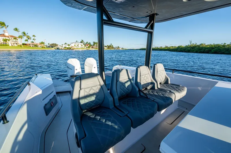 Chye-lukh Yacht Photos Pics 2021 Axopar 37 boat interior with luxurious seating on a scenic waterway.