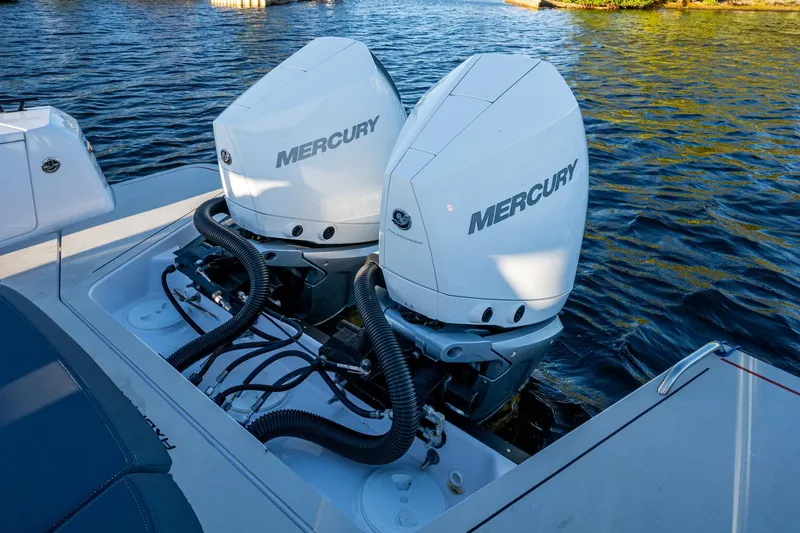 Chye-lukh Yacht Photos Pics Twin Mercury outboard engines on a 2021 Axopar 37 boat, docked on water.