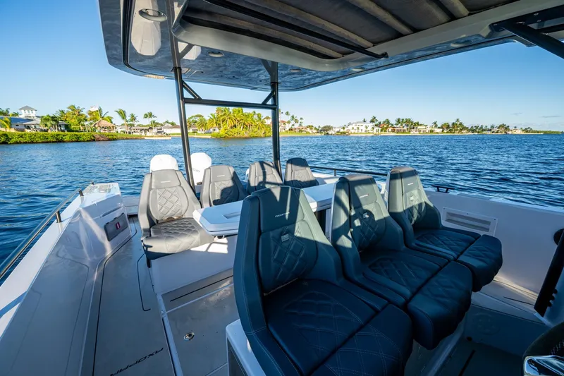 Chye-lukh Yacht Photos Pics 2021 Axopar 37 boat interior with luxurious seating, cruising on a scenic waterway.