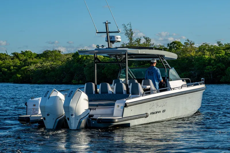 Chye-lukh Yacht Photos Pics 2021 Axopar 37 boat cruising on a serene waterway with lush greenery.