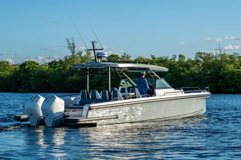 Chye-lukh Yacht Photos Pics 2021 Axopar 37 boat cruising on a calm river with lush greenery.
