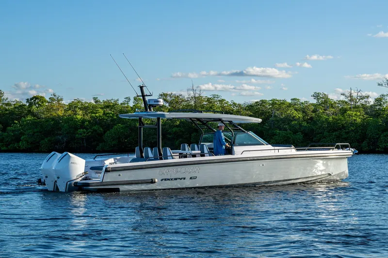 Chye-lukh Yacht Photos Pics 2021 Axopar 37 boat cruising on a calm river with lush green trees.