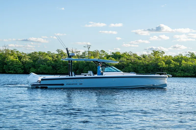 Chye-lukh Yacht Photos Pics 2021 Axopar 37 boat cruising on a calm river with lush green trees.