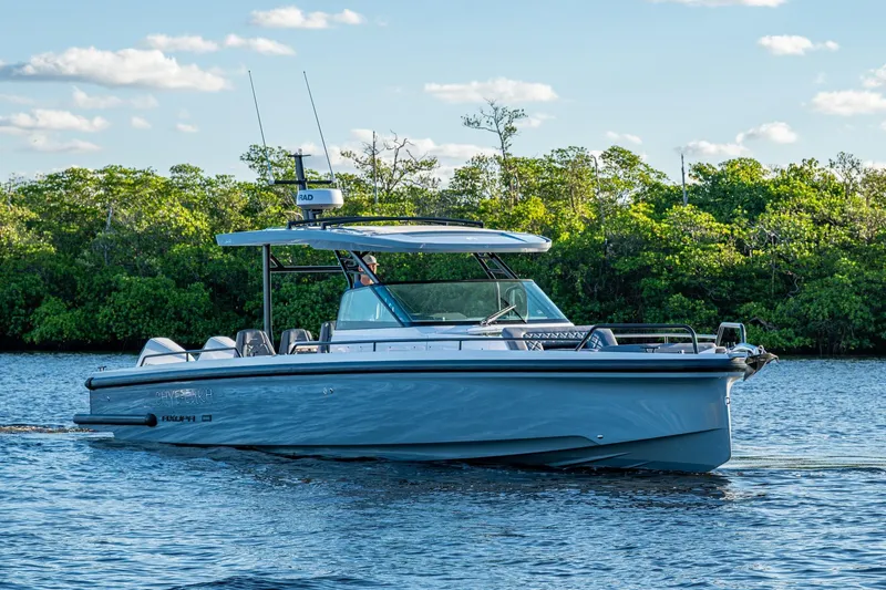Chye-lukh Yacht Photos Pics 2021 Axopar 37 boat cruising on a calm river with lush greenery.