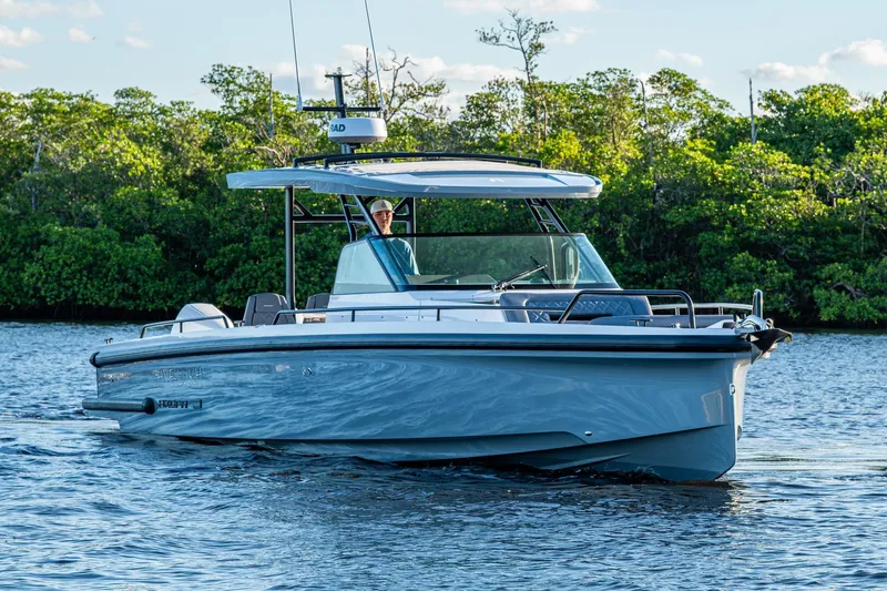 Chye-lukh Yacht Photos Pics 2021 Axopar 37 boat cruising on a calm river with lush greenery in the background.