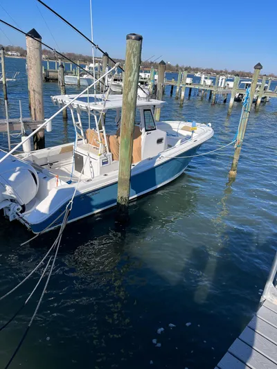  Yacht Photos Pics 2022 Edgewater 285CC boat docked in a marina on a sunny day.