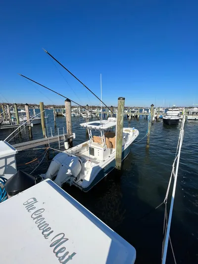  Yacht Photos Pics 2022 Edgewater 285CC boat docked in a marina under clear blue skies.
