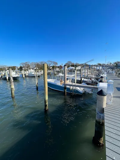  Yacht Photos Pics 2022 Edgewater 285CC boat docked at marina under clear blue sky.