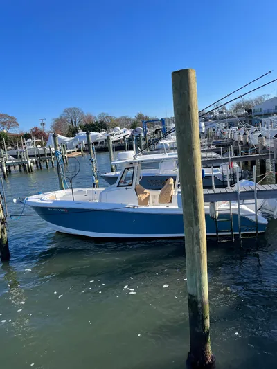  Yacht Photos Pics 2022 Edgewater 285CC boat docked in a marina on a sunny day.