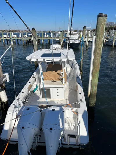  Yacht Photos Pics 2022 Edgewater 285CC boat docked at marina with twin engines.