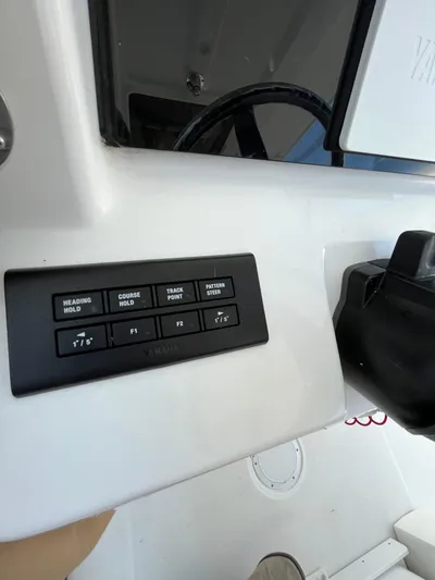  Yacht Photos Pics 2022 Edgewater 285CC boat dashboard with control panel and steering wheel.