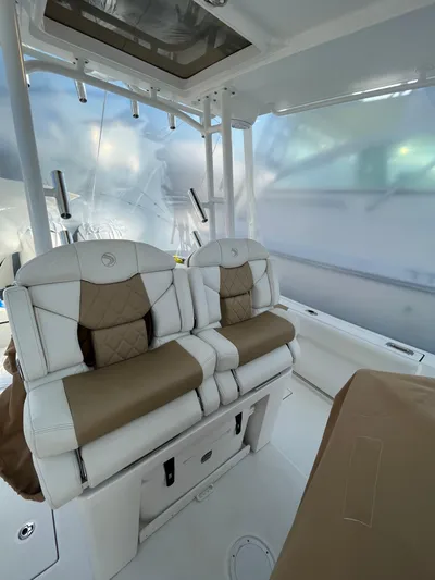  Yacht Photos Pics 2022 Edgewater 285CC boat interior with cushioned seating and modern design.