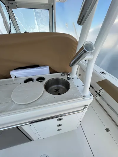  Yacht Photos Pics 2022 Edgewater 285CC boat interior with sink and rod holders.
