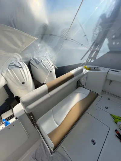  Yacht Photos Pics 2022 Edgewater 285CC boat interior with dual engines and seating area.