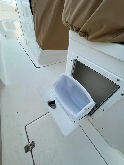  Yacht Photos Pics 2022 Edgewater 285CC boat storage compartment with open hatch, showcasing interior space.