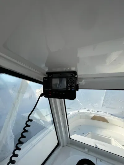  Yacht Photos Pics 2022 Edgewater 285CC boat interior with mounted navigation equipment.
