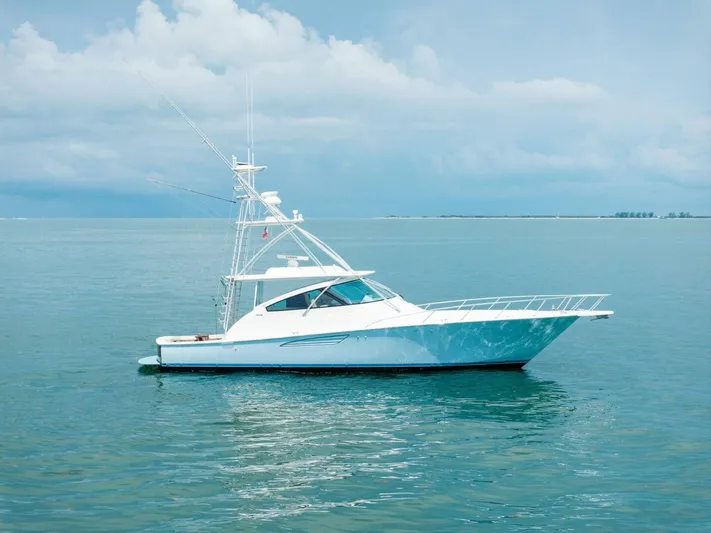 Terrabbean Yacht Photos Pics 2015 Viking 52 Open yacht on calm ocean waters under a cloudy sky.