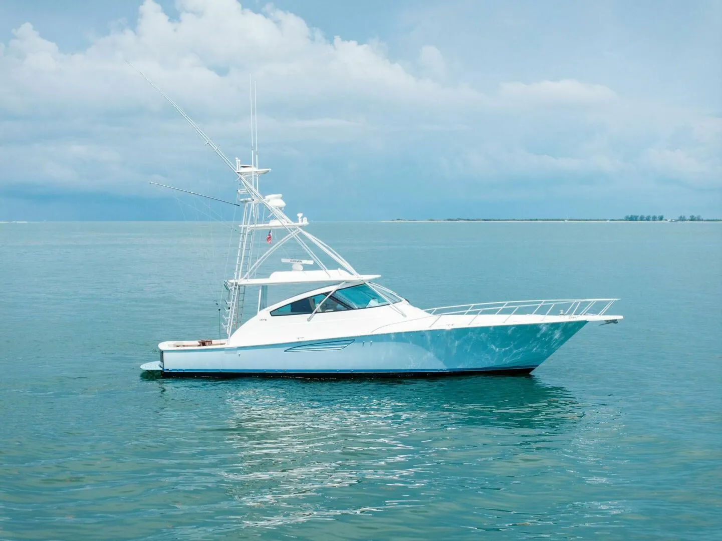 2015 Viking 52 Open yacht on calm ocean waters under a cloudy sky.