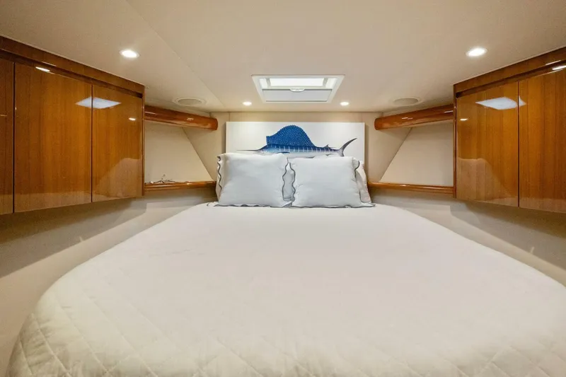 Terrabbean Yacht Photos Pics Luxurious cabin interior of 2015 Viking 52 Open yacht with cozy bedding and wooden cabinets.