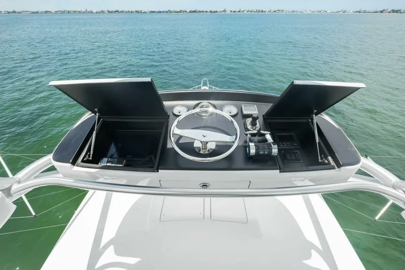 Terrabbean Yacht Photos Pics 2015 Viking 52 Open yacht helm with ocean view, featuring steering wheel and controls.