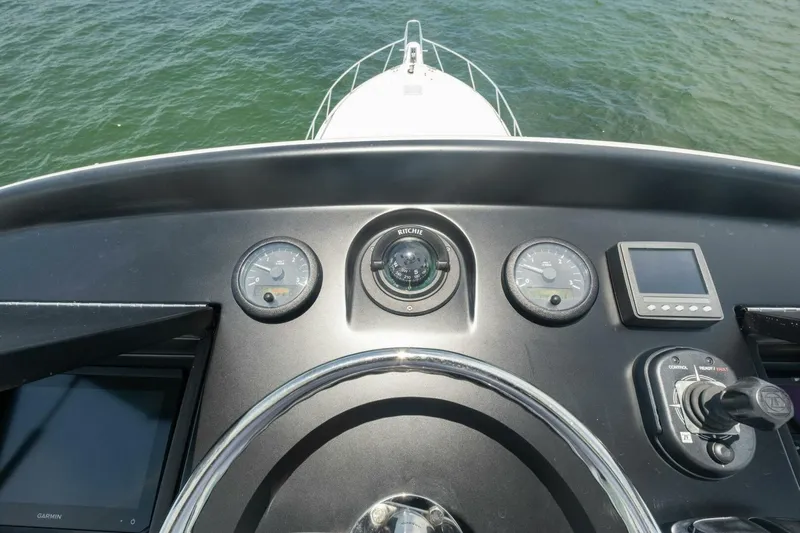 Terrabbean Yacht Photos Pics Control panel of a 2015 Viking 52 Open yacht, featuring gauges and navigation equipment.
