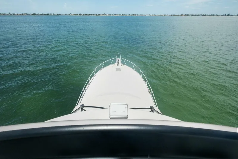 Terrabbean Yacht Photos Pics Bow view of 2015 Viking 52 Open yacht cruising on calm waters.
