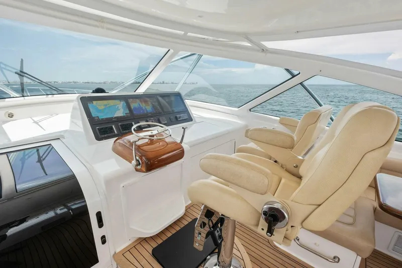 Terrabbean Yacht Photos Pics Luxurious helm of 2015 Viking 52 Open yacht with dual beige captain chairs.
