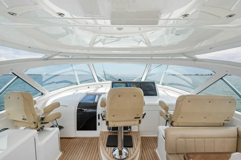 Terrabbean Yacht Photos Pics Interior view of 2015 Viking 52 Open yacht cockpit with beige seating and navigation controls.