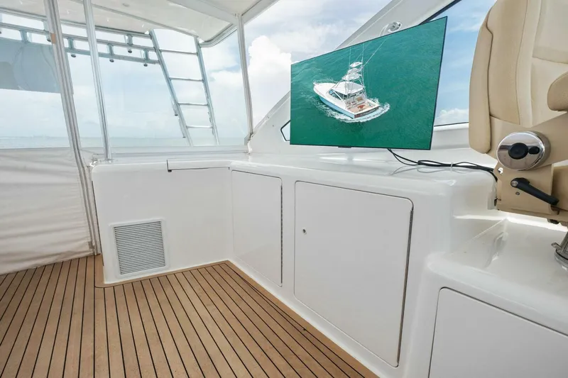 Terrabbean Yacht Photos Pics 2015 Viking 52 Open yacht interior with wooden flooring and mounted screen.