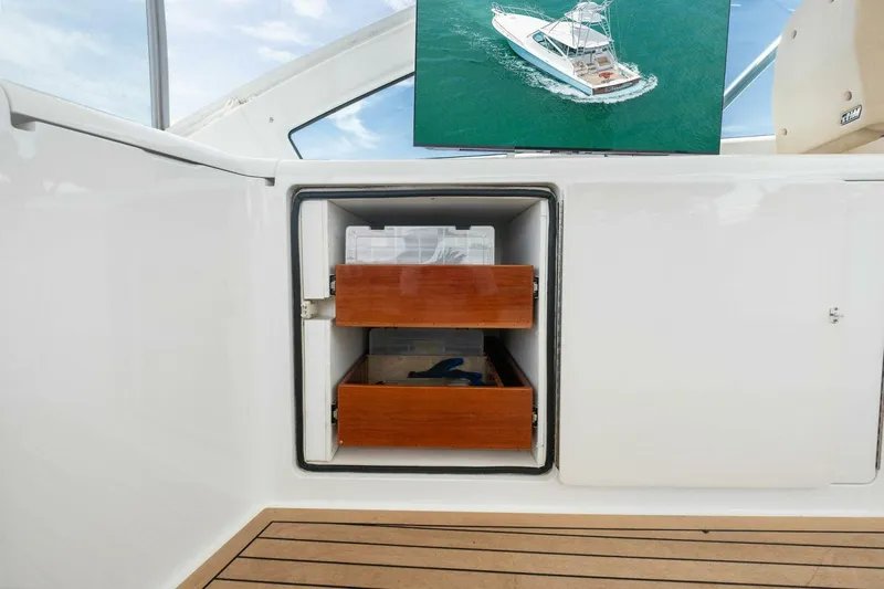 Terrabbean Yacht Photos Pics 2015 Viking 52 Open yacht interior with open storage drawers and a deck view.