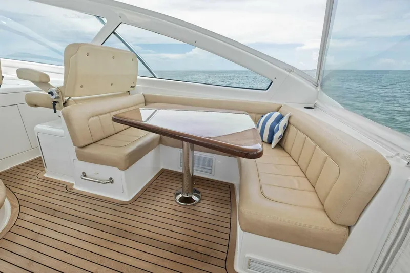 Terrabbean Yacht Photos Pics Luxurious interior of 2015 Viking 52 Open yacht with beige seating and wooden table.