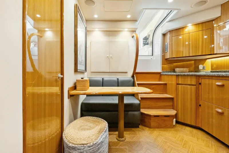 Terrabbean Yacht Photos Pics Luxurious interior of 2015 Viking 52 Open yacht with wooden cabinetry and cozy seating area.