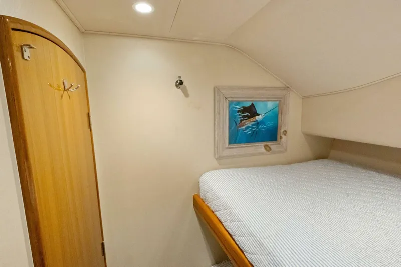 Terrabbean Yacht Photos Pics 2015 Viking 52 Open cabin interior with bed, wooden door, and fish artwork.