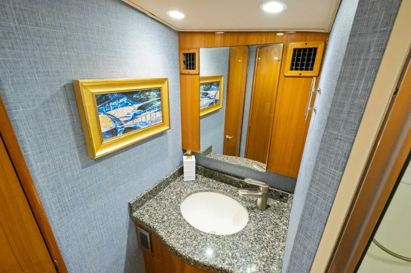Terrabbean Yacht Photos Pics Luxurious bathroom in 2015 Viking 52 Open yacht with granite countertop and framed artwork.