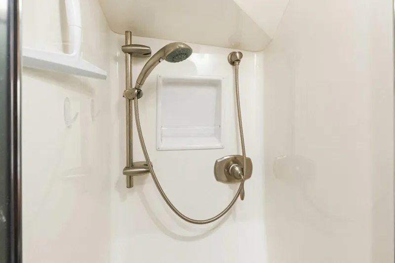 Terrabbean Yacht Photos Pics Shower area in 2015 Viking 52 Open yacht with handheld showerhead and built-in shelf.