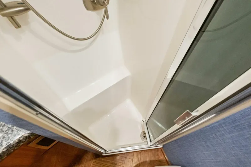 Terrabbean Yacht Photos Pics Shower area in 2015 Viking 52 Open yacht, featuring modern fixtures and glass door.