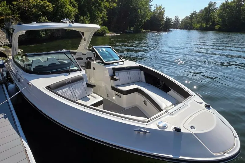  Yacht Photos Pics 2019 Sea Ray 350 SLX boat docked on a serene lake with lush greenery.