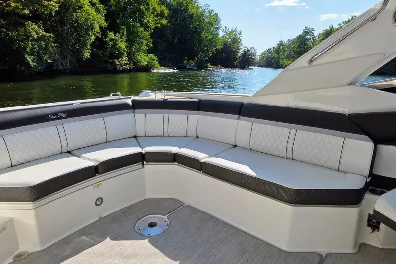  Yacht Photos Pics Luxurious seating on 2019 Sea Ray 350 SLX boat, surrounded by scenic water and greenery.