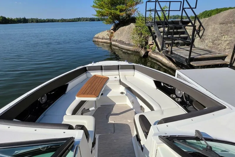  Yacht Photos Pics 2019 Sea Ray 350 SLX boat docked by a scenic lakeside with lush greenery.