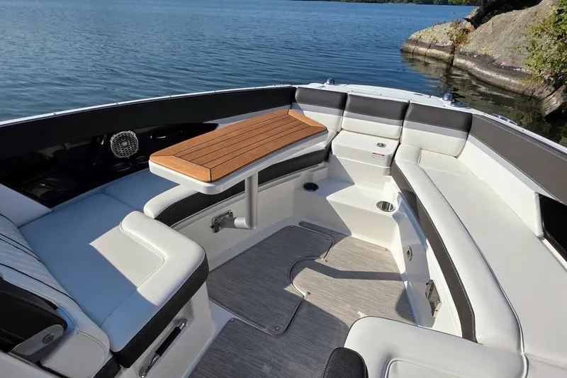  Yacht Photos Pics 2019 Sea Ray 350 SLX boat interior with seating and table on a calm lake.