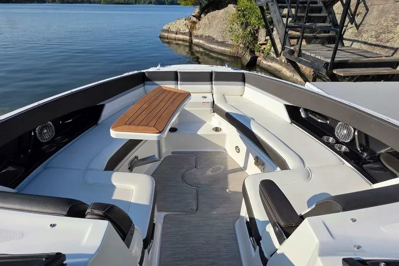  Yacht Photos Pics 2019 Sea Ray 350 SLX boat interior with seating and wooden table, docked by a lake.