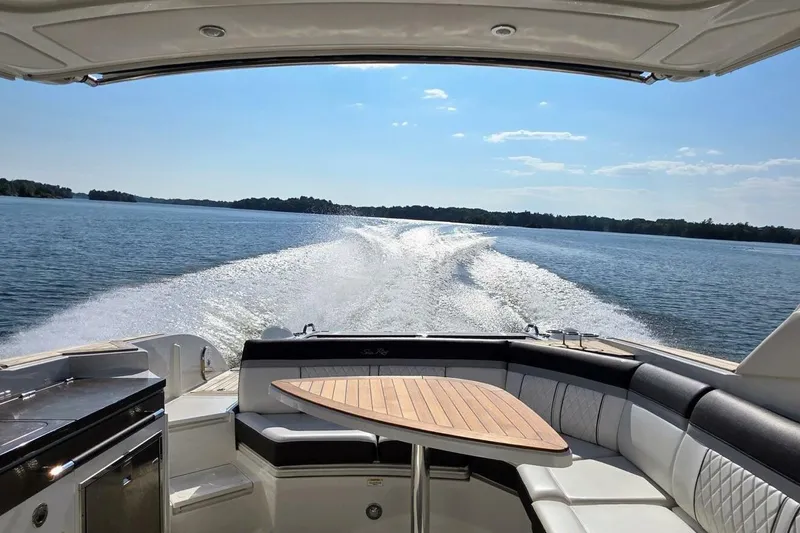  Yacht Photos Pics 2019 Sea Ray 350 SLX cruising on a sunny lake, featuring luxurious seating and table.
