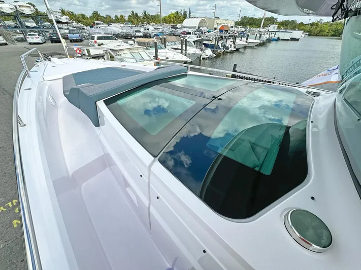  Yacht Photos Pics 2024 Axopar 37XC CROSS CABIN boat docked at marina, showcasing sleek design and spacious cabin.