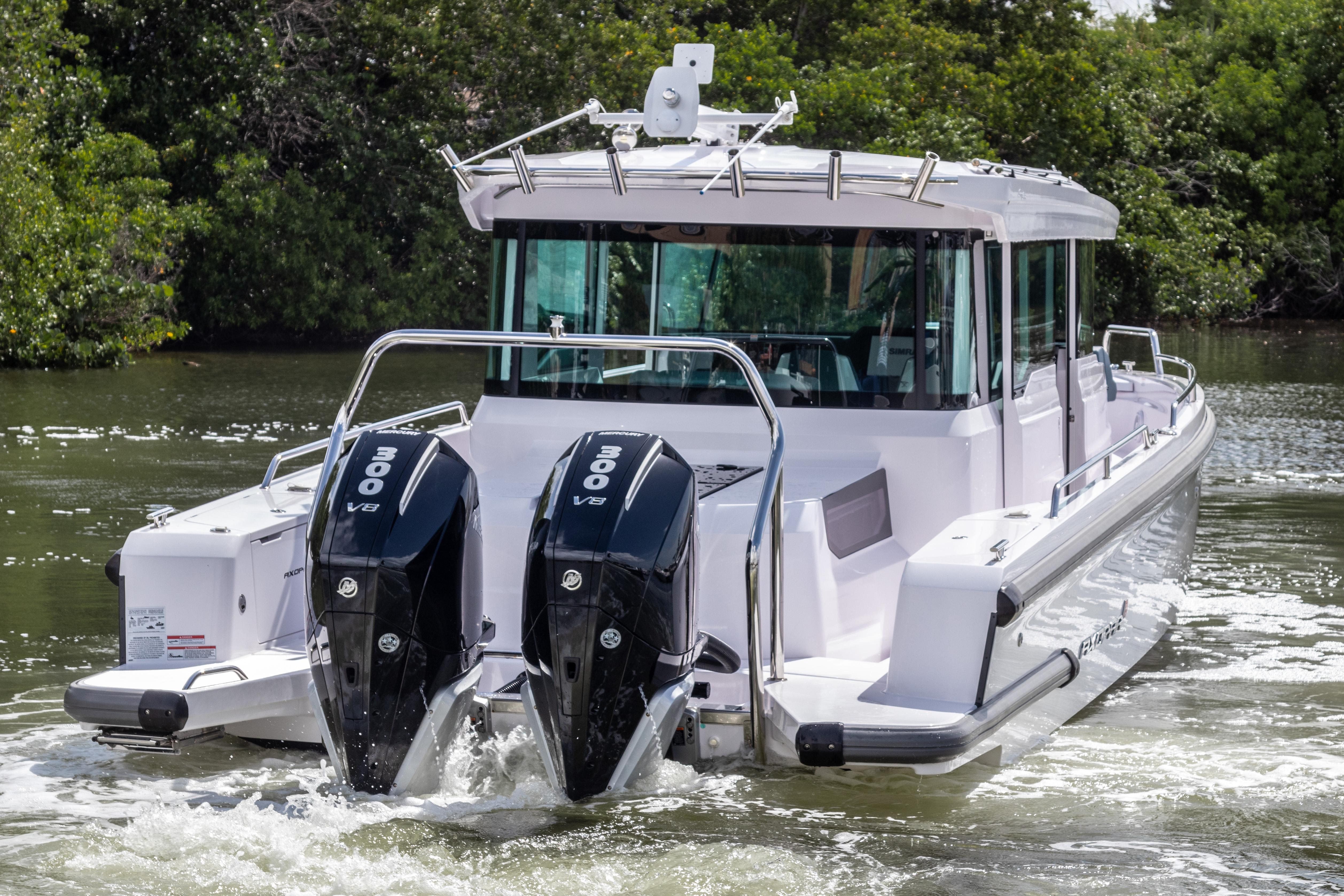 2024 Axopar 37XC CROSS CABIN with dual 300 V8 engines cruising on water.