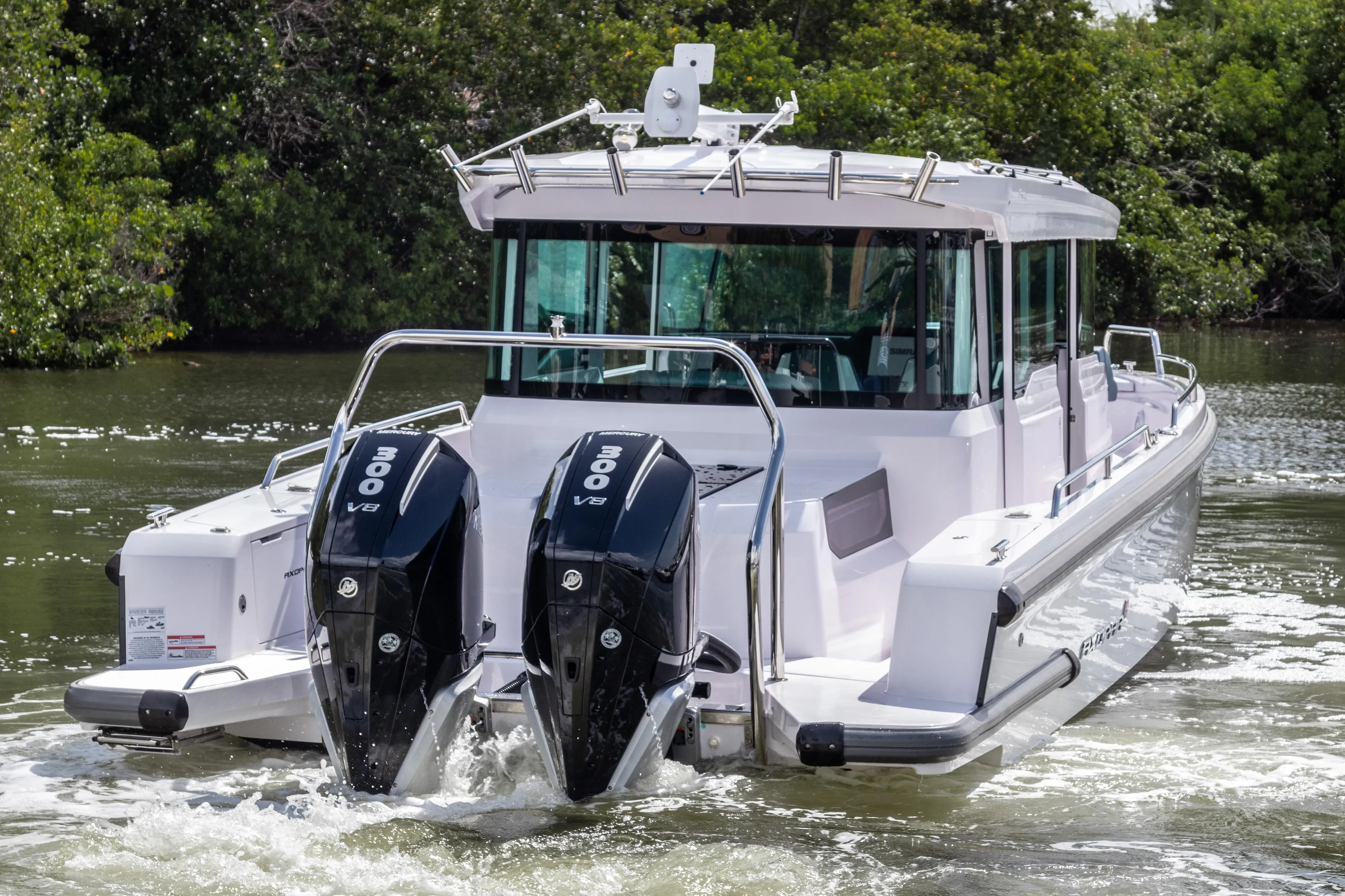 2024 Axopar 37XC CROSS CABIN with dual 300 V8 engines cruising on water.