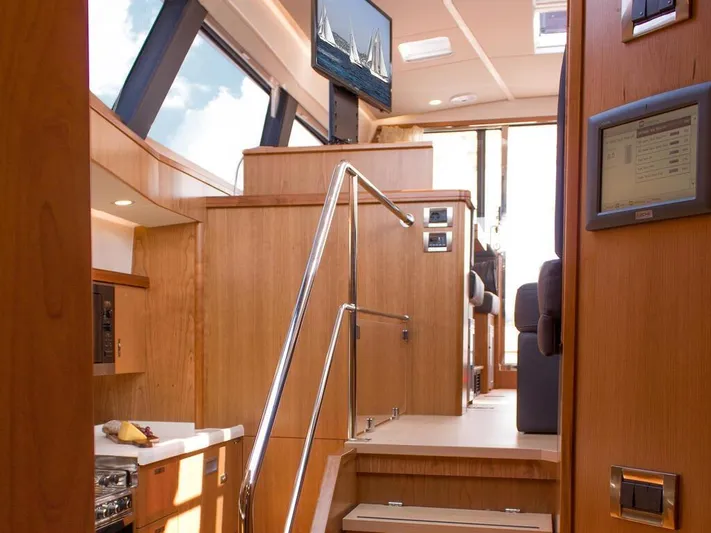  Yacht Photos Pics Luxurious interior of 2025 Moody 54 DS yacht with modern wood finishes and sleek design.