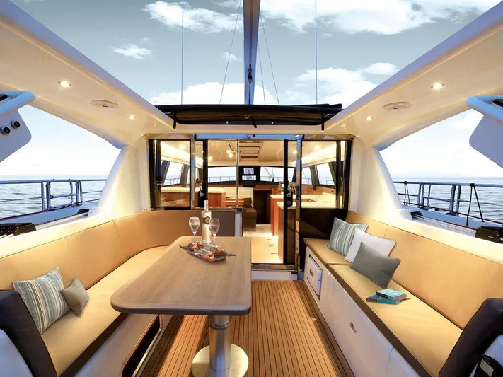  Yacht Photos Pics Luxurious interior of 2025 Moody 54 DS yacht with elegant seating and ocean view.