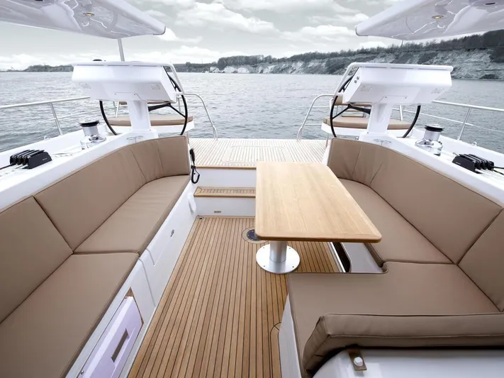  Yacht Photos Pics Luxurious Moody 54 DS yacht deck with seating and table, overlooking serene waters, 2025 model.