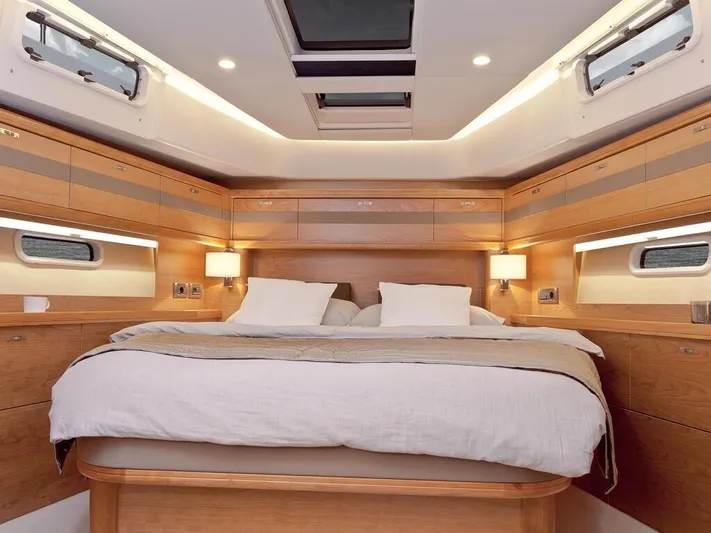  Yacht Photos Pics Luxurious cabin interior of 2025 Moody 54 DS yacht with elegant wood finish.