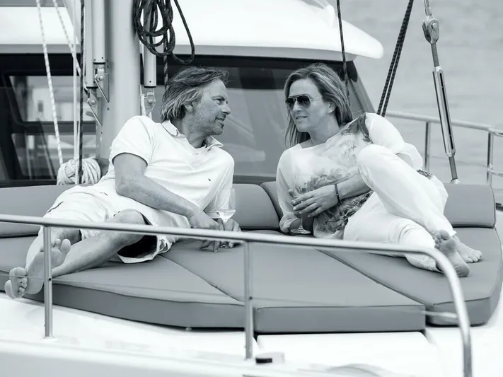  Yacht Photos Pics Couple relaxing on a 2025 Moody 54 DS yacht deck, enjoying a conversation.
